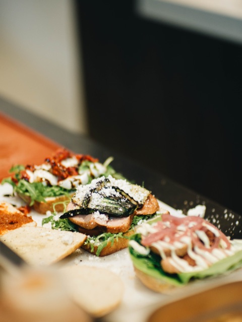A board with meatball sandwiches from Meat The Balls with eight toppings from around the world.